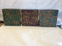 Three Embossed Metal Decorative Wall Hangings