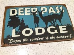 Deer Pass Lodge metal sign “Enjoy the comfort of outdoors”